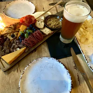 a platter of appetizers and a glass of beer