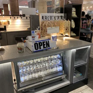 a counter with a display of popcorn
