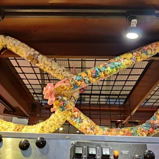 Mochi crunch lei vs. Colored popcorn lei