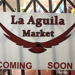 a white sign with a red eagle on it