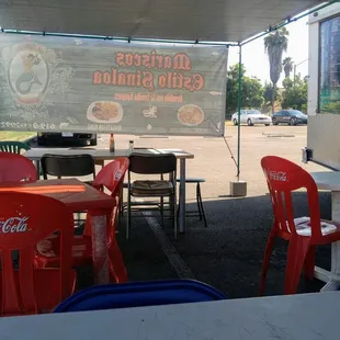 tables and chairs under a canopy