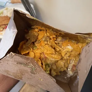 a person holding a box of food