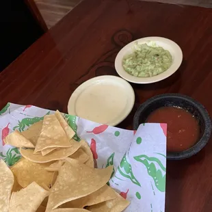 Chips, salsa, guacamole, and cheese dip.