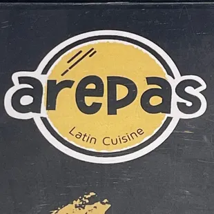 a black box with a yellow logo