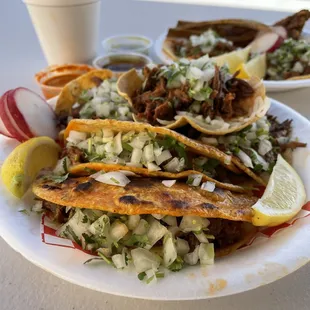 a plate of tacos and a drink