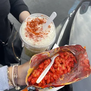 a woman holding a bag of strawberries