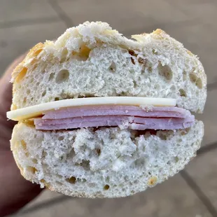 a hand holding a sandwich