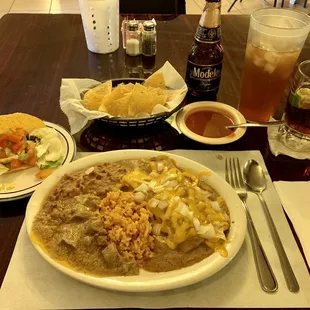 Tex-Mex (2 enchiladas beef and carne guisada) with rice and beans. Added a crispy beef taco. Chips and salsa a negro Modelo and iced tea.