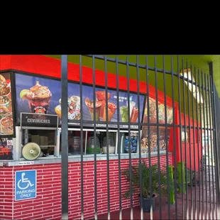 a red brick building with a black gate