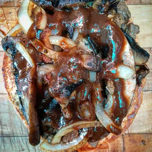 The Steak House Torta. Carne Asada, Sauteed Onions and Portobello Mushrooms topped with A-1 Steak Sauce.