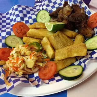 Yuca con Chicharrón. Pork was juicy, Curtido was spicy and very very tasty. Cucumber and tomato were a fresh touch.