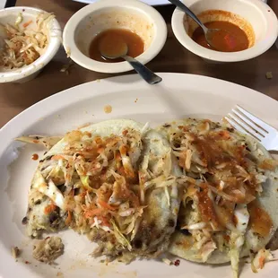 2 mixed (pork, beans, cheese) pupusas on each plate with the toppings