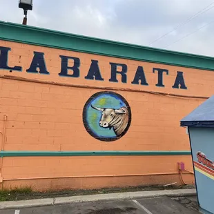 a cow on the side of the building