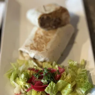 a plate of salad and a burrito
