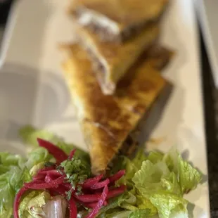 a plate of salad and a sandwich
