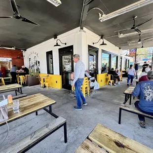 people sitting at tables in a restaurant