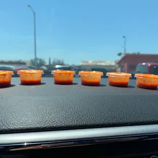 a row of plastic cups on the dashboard of a car