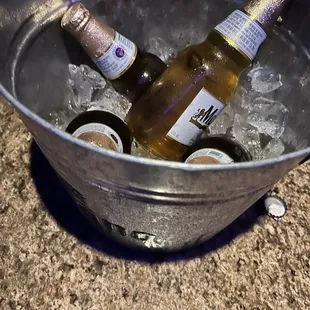 two bottles of beer in a bucket