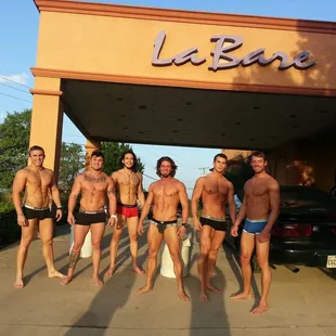 a group of men standing in front of a building