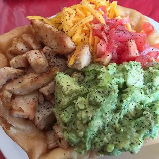 Fried corn tortilla bowl ( have to ask for corn) beans on the bottom, fajita chicken, cheese, lettuce, tomato, and GUACAMOLE!