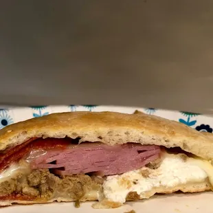 After looking real hard I find Italian sausage in the Italian sausage calzone. Way too much Canadian bacon.