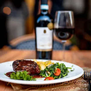 a plate of food and a glass of wine