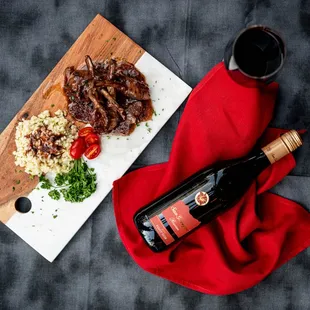 a plate of food and a bottle of wine