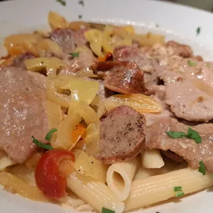 a plate of pasta with meat and vegetables