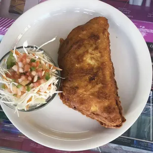 Enchiladas Nicaragüenses: rice and beef wrapped inside a corn tortilla.