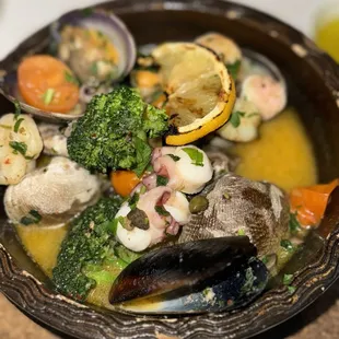 Oven baked shrimp, squid, clams, and octopus tossed with seasonal vegetables