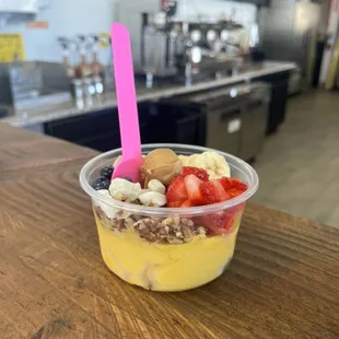 Regular mango açaí bowl with walnuts, blueberries, strawberries, banana, peanut butter and mochi.