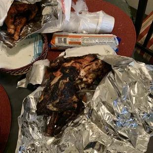 two pieces of chicken wrapped in tin foil