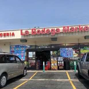 two cars parked in front of the store