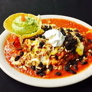The famous La Bodega Chile Rellenos. Smothered in our savory red sauce topped with Pecans Raisins &amp; Sour Cream. Yummy!