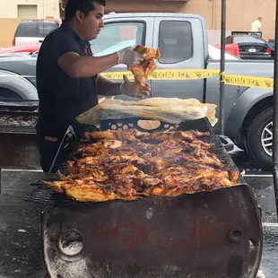 a man cooking chicken