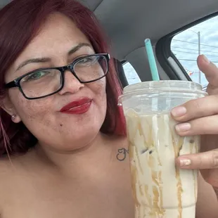 a woman holding a drink