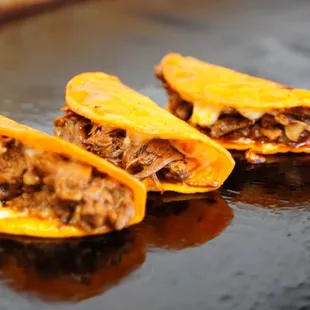 three tacos on a grill