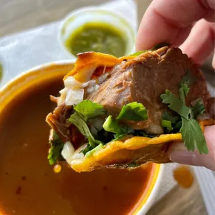 Last bite of quesabirria taco (comes with a piping hot cup of savory broth)