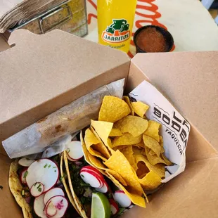 Lunch box! 2 Tacos, chips and salsa and 2 churros. Pineapple soda was extra