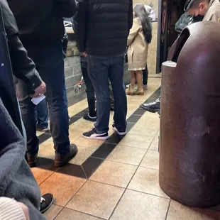 a group of people waiting in a subway