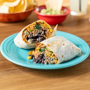 a burrito cut in half on a blue plate