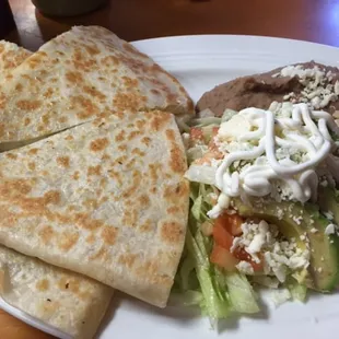 Carne asada quesadilla with salad and rice and beans. Delicious!