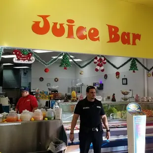 a man standing in front of a juice bar