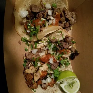 two tacos with meat and vegetables