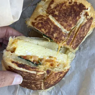 Egg, tomato, basil &amp; cheddar breakfast sandwich on a croissant. So good!