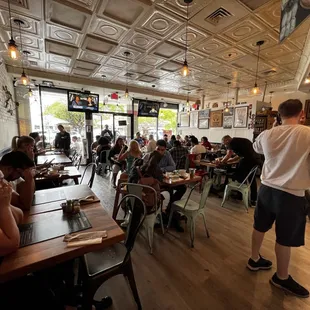 people sitting at tables in a restaurant