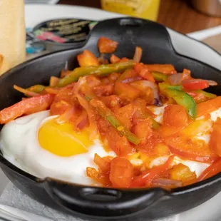 a fried egg with peppers and onions