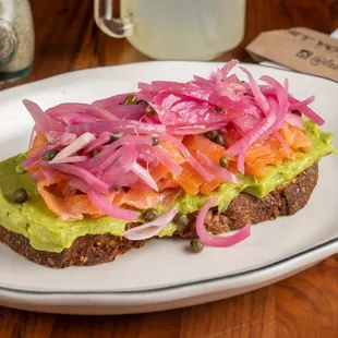 Smoked Salmon avocado toast with pickled onions and capers.