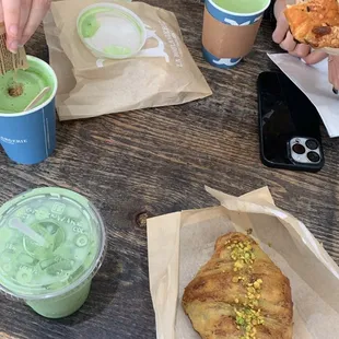 two people eating pastries