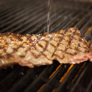 a steak being cooked on a grill